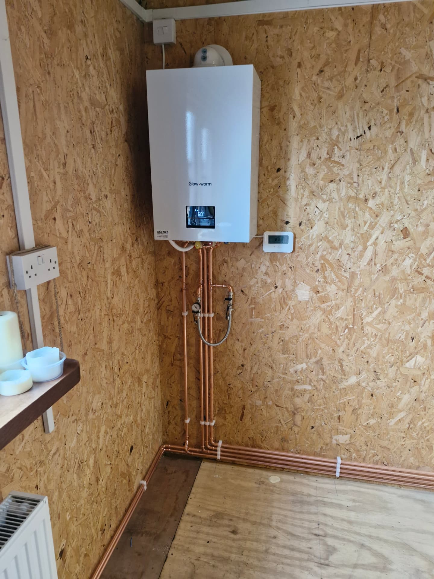 Glow-worm boiler installed in a timber outbuilding with copper pipework