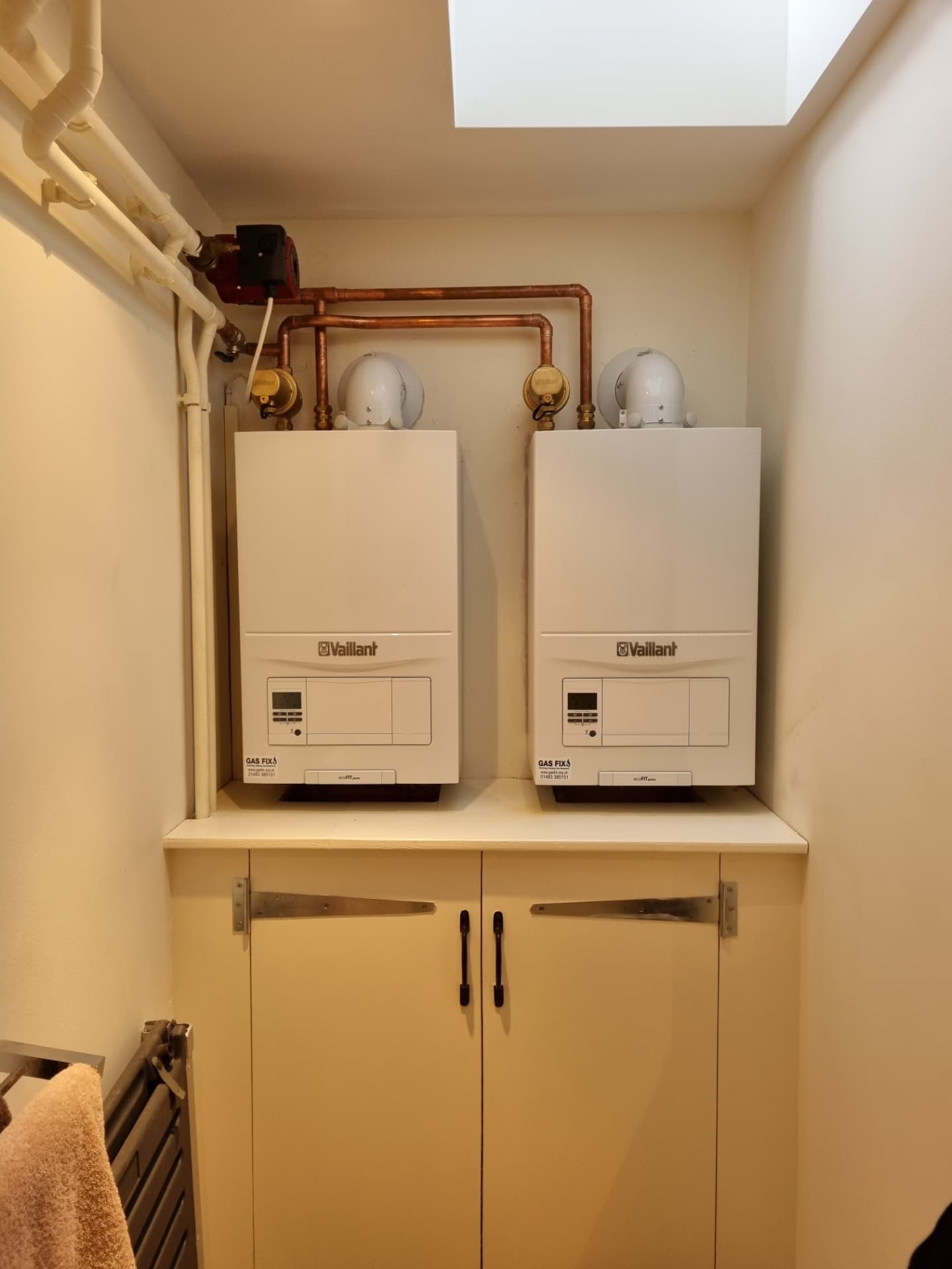 Two Vaillant boilers installed side by side in a cupboard