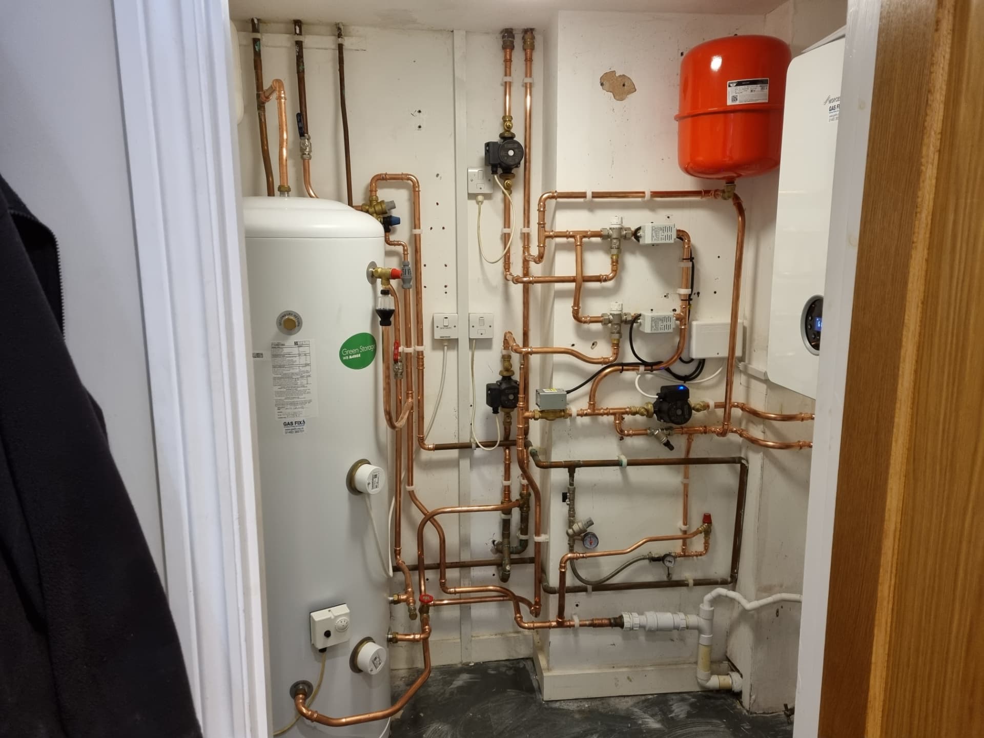 Hot water cylinder, pumps and Worcester boiler in a plant cupboard