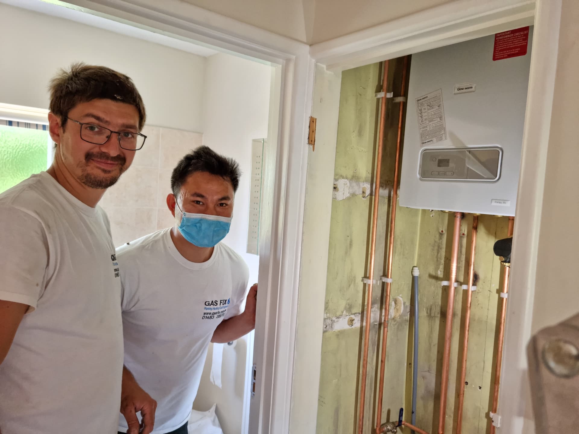 Gas Fix engineers beside a newly installed Glow-worm combi boiler